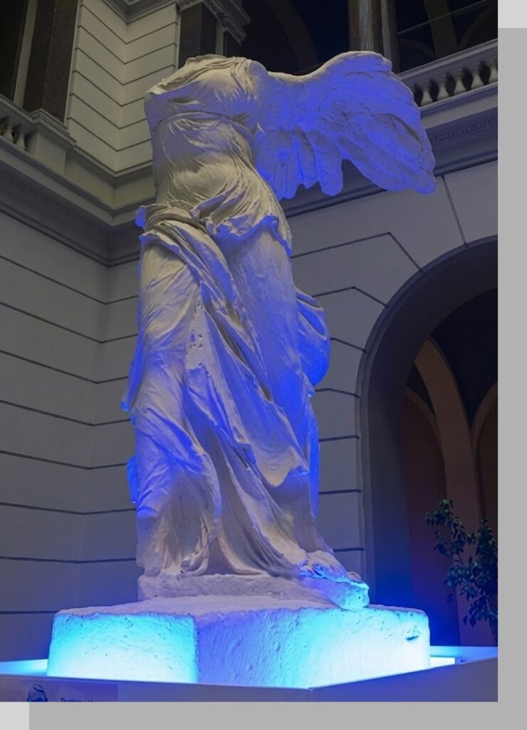 The Lasker emblem: the winged Nike of Samothrace, lit in blue